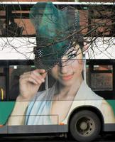 Bus advert showing stylish woman in hat