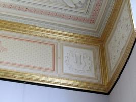 Ornate gold trim and frou-frou design on ceiling