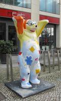 Painted statue of a bear with arms uplifted; painted with undersea creatures and diving goggles