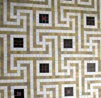 Rectangular maze-like tile pattern in brown and white with black squares