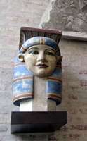 Painted Greek bust of person in Egyptian style headdress.