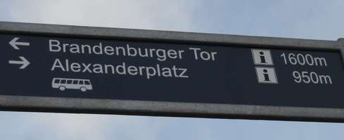 Sign showing direction and distance to Brandenburg Gate and Alexanderplatz