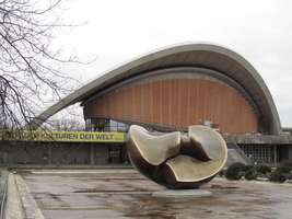 Oyster-shaped building (House of World Cultures) with somewhat spherical sculpture in front