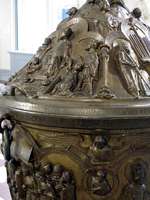 Detail of baptismal font with sculptures of holy people