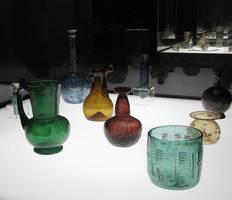 Green, blue, yellow, and red glass vases and jars