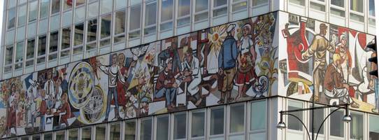 Painting of workers on side of office building