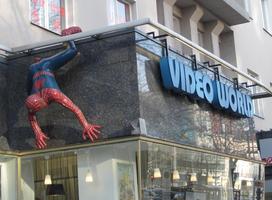 3-d lifesize Spiderman crawling on side of Video World sign