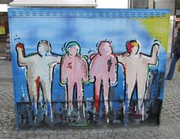 Power box painted with outlines of people filled in with pastel colors