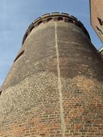 Round brick tower photographed from steep upward angle