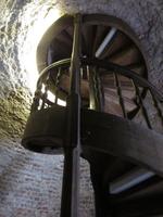 Spiral wooden staircase inside tower, leading to first level of tower