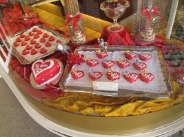 Red pastry valentine hearts labeled “Ich Liebe Dich” (I Love You) in bakery window