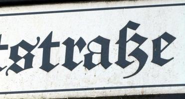 Street sign section showing modern lowercase “s” in word “straße”