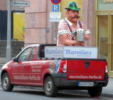 Pickup truck for maxilimians-berlin.de, in back is a large sculpture of a man in tyrol hat with beer stein