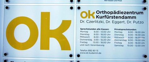 Curvy letter “k” in sign for ok: Orthopedic Center Kurfürstendamm