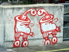 Graffitti showing two roller skates with what appear to be pipes (for smoking) in the top.