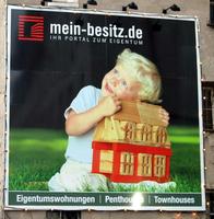 Advert for real estate firm, depicting über-cute child with a toy house.