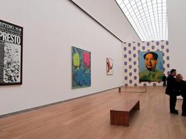 Gallery of art by Andy Warhol; his portrait of Mao Tse-Tung is highlighted at back of gallery