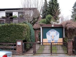 House with cartoon rhinoceros painted on garage door