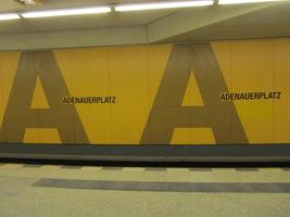 Walls of Adenauerplatz subway station; painted yellow with large letter A made of individual small dots