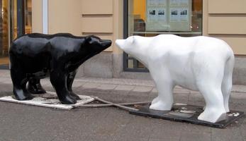 sculpture of black and white bears, nose to nose