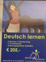 Subway advert for German language academy; shows woman leaping in front of Brandenburg gate