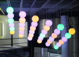 Spherical lamps hanging from ceiling; yellow and purple