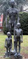 sculpture of nude man with two nude children
