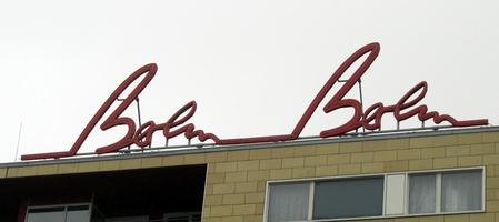 Sign on top of Berlin Berlin hotel; red script letters