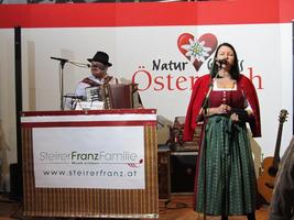 Male accordion player and female singer in Austrian folk clothing