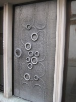 silver metal door with circular rings on it