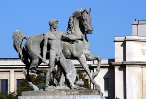 sculpture of horse and human standing at its side