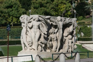 blocky sculpture of men, women, and cherubs