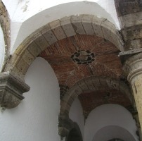 view of old stone archway, looking up at ceiling