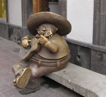 seated chubby guitar player in sombrero