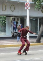 older man in purple bell-bottoms, on roller skates