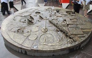 a large round metal sculpture in shopping area