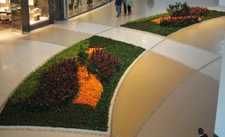 design laid out in orange and red flowers on grass