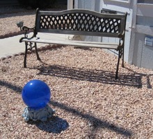 blue glass globe in front of bench