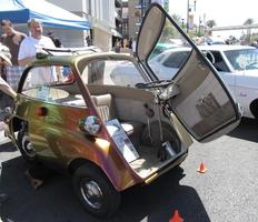 An Isetta with the front of the car opened up.