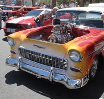 Yellow car w. red decoration; engine protruding through hood area.