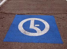 minimalist “handicapped parking” logo on parking lot surface