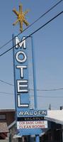 Blue sign for Motel Walden; sign has gold asterisk on top.