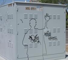 Graffitti silhouette of a young man on a power box
