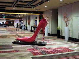 Large sculpture of a pink high-heeled shoe