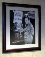Jack Benny in front of slot machine labeled 'This machine reserved for Jack Benny'