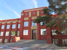 long view of high school; red adobe building