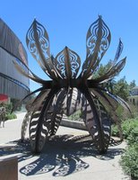 large metallic sculpture resembling an insect made of leaves