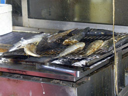 Fish grilling outside restaurant 