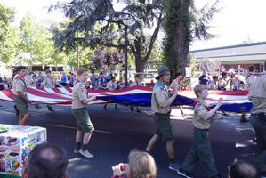 Boy Scouts carrying large US flag