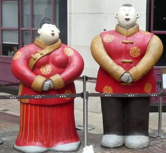 sculpture of man and woman in traditional chinese garb